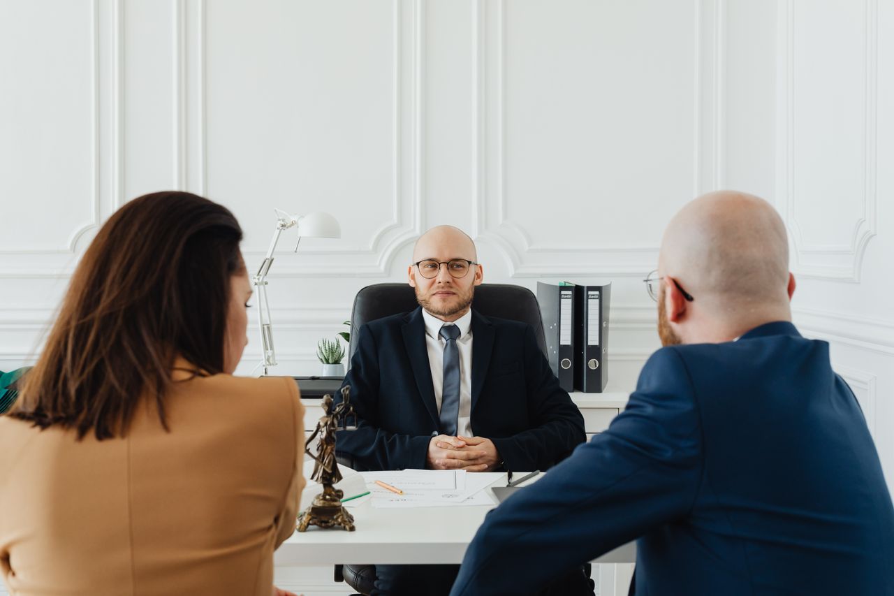 A lawyer meeting two clients about a family-law matter